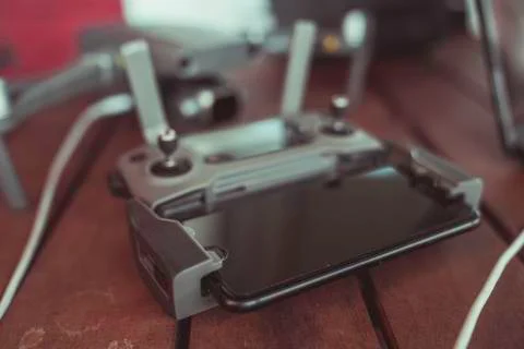 Drone quadcopter with a flight controller and notebook on the old wooden table. Stock-Fotos