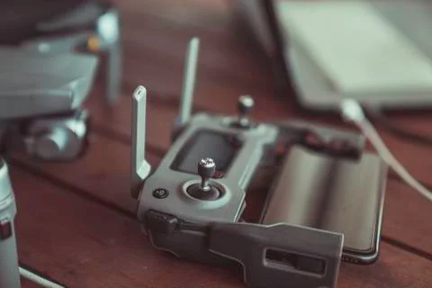 Drone quadcopter with a flight controller and notebook on the old wooden table. Stock-Fotos