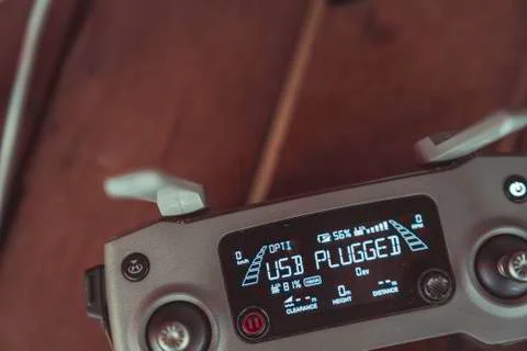 Drone quadcopter with a flight controller and notebook on the old wooden table. Stock Photos