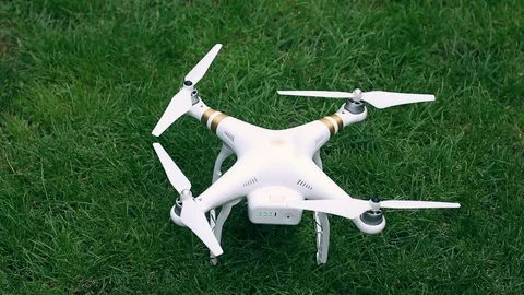 Drone Quadcopter Landing on Grass And Turns Off Stock Footage