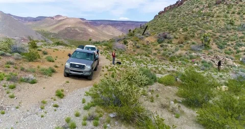 Drone quickly flying through desert canyon between two hills Video stock 114775842