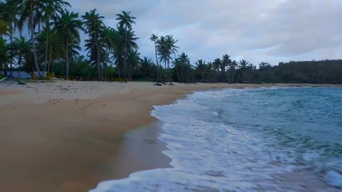 Drone racing along a beach as the waves roll in 스톡 동영상 124879245