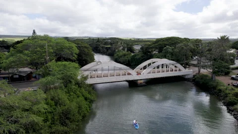 Drone rainbow bridge drone down and camera tilt up with kayaker and Stand up Stock Footage 170021612