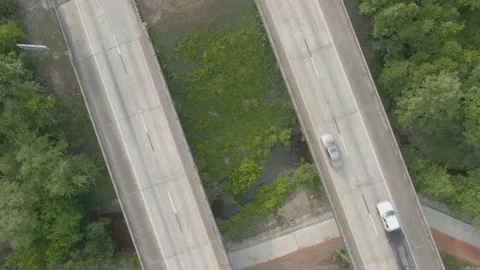 Drone raising up and looking down from middle of overpass while cars and Stock Footage 142387628