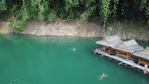 From the drone a receding view of the bungalows standing on the water with Stock Footage 128732155