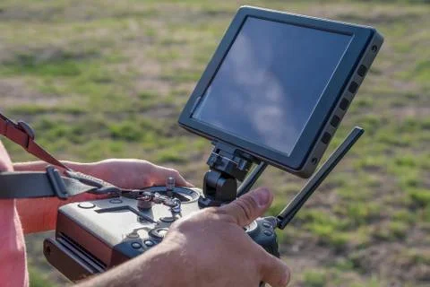 Drone remote control in hand man.Man operating of flying drone Stock Photos