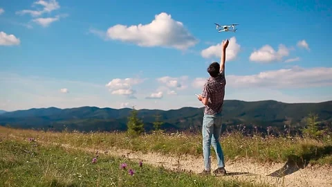 Drone remote control. Man ends operating copter controller in mountains Stock Footage 141396009