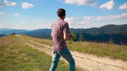 Drone remote control. Man operates copter controller in mountains. Aerial video Stock Footage 141396018