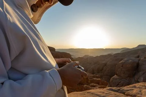 Drone remote control settings screen hands close up with desert background Stock Photos