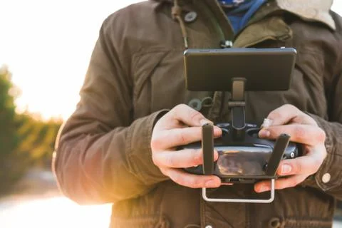Drone remote controller joystick transmitter in the young man hands  Stock Photos