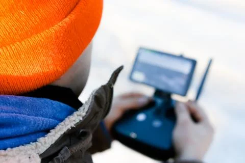 Drone remote controller joystick transmitter in the young man hands  Stock Photos