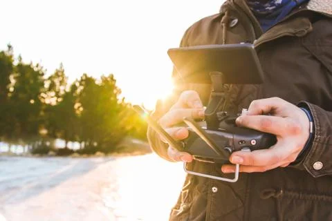 Drone remote controller joystick transmitter in the young man hands  Stock Photos