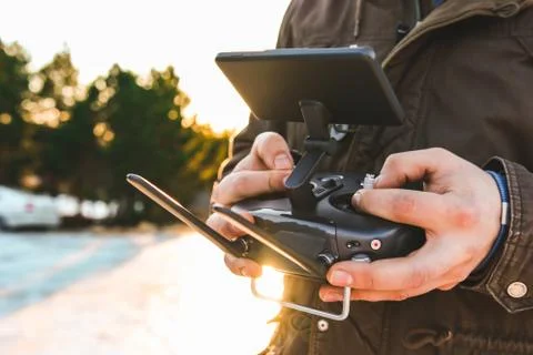 Drone remote controller joystick transmitter in the young man hands  Stock Photos