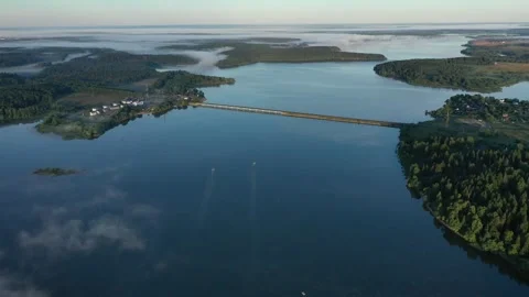 Drone retreating over calm river with bridge Stock Footage 320060262