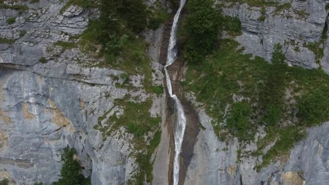 Drone Reveal of Alpine Waterfall – Pullback with Downward Tilt Stock Footage 313562920