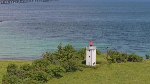 Drone Reveal of Knudshoved Lighthouse with the Great Belt Bridge on the Stock Footage 346747224