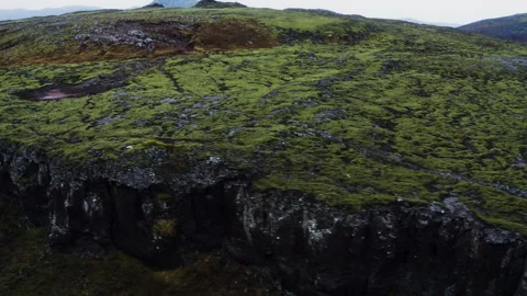 Drone Reveal Over Moss-Covered Icelandic Volcanic Cliff Edge Stock Footage 339081172
