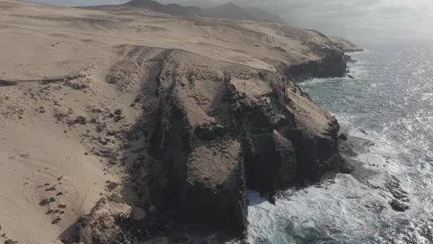 Drone Reveal of Rugged Coastal Cliffs and Ocean with Seabirds Stock Footage 346788199