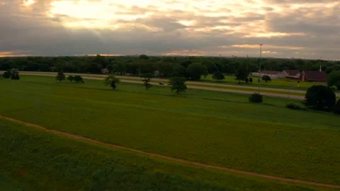 Drone reveal of sun rays through clouds during warm sunrise in Wichita Kansas 4k Stock Footage 157791267