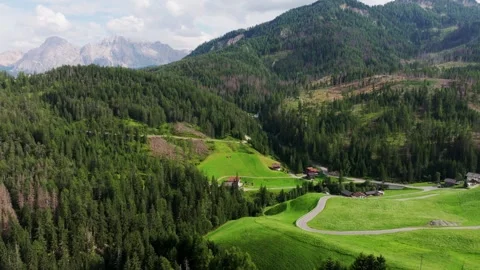 Drone reveals rolling meadows forests and mountain scenery beneath clouds Stock Footage 337560811