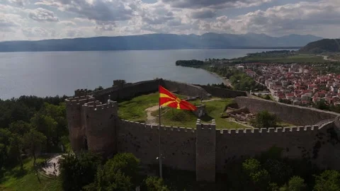 Drone Reverse Parallax of Samuel's Fortress and Waving Flag over Lake Ohrid Vídeos de archivo 337177628