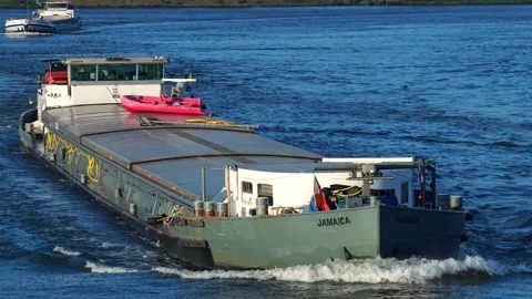 Drone reverse shot of cargo vessel on Dordrecht canal Stock Footage 314043792