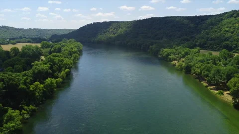 Drone reversing above a Norfork river with rolling hills of trees Stockbeeldmateriaal 200981817