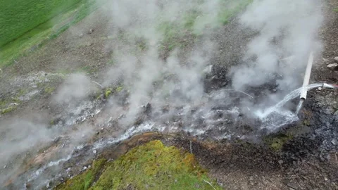 Drone rise and pull back from geothermal steam in Djupidalur valley, Iceland Stock Footage 346551660