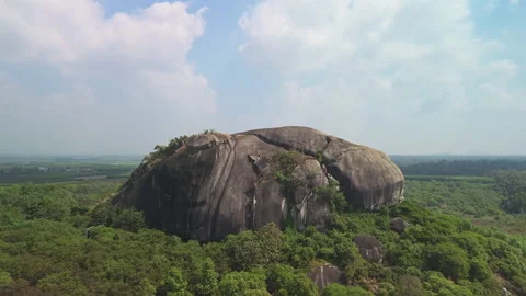 Drone Rise Revealing Forest-Surrounded Inselberg in Southern Vietnam Stock Footage 329914723
