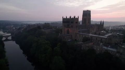Drone rises above Durham Cathedral in morning twilight Stock Footage 276416272