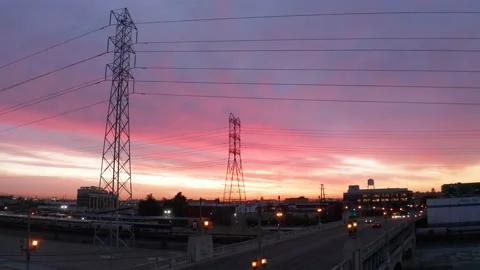 Drone rises above powerlines at sunset in Los Angeles Stock Footage 145045198