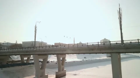 The drone rises above the road bridge in winter. Cars move along the road bridge Video stock 195954047