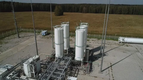 The drone rises above the storage tanks for gaseous substances. Industrial tanks Stock Footage 169587439