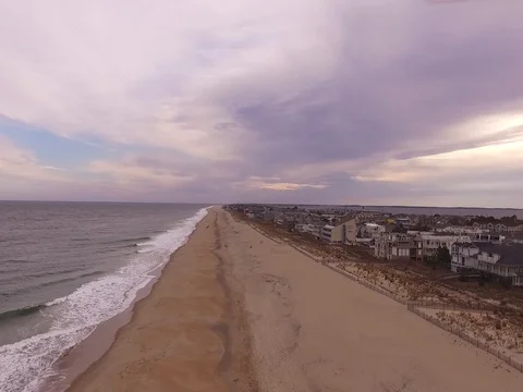 Drone rises and pans down over beach Stock Footage 82574922