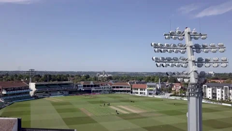 Drone rises up behind floodlight cricket Stock Footage 136218484