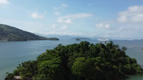 Drone rises behind small tropical Island and reveal a stunning bay Stock Footage 331299311