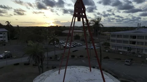 Drone rises up in close up of Dreyfus Tower at sunset in Kourou, French Guiana Stock Footage 289130774