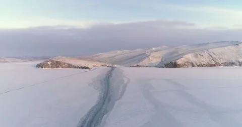 Drone Rises Descends Over Trail Left by a Boat on the Ice of a Frozen Lake Stock Footage 143526206