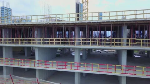 Drone rises up the floors of a multi-storey building under construction Video stock 200949960