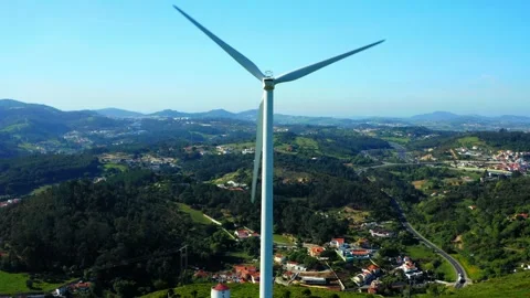 Drone rises in front of a wind turbine generating electricity against the b.. Stock Footage 261804448