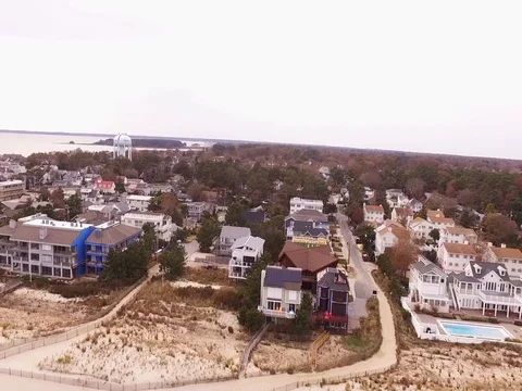 Drone rises over Beach town Stock Footage 82574749