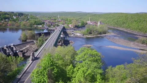 A Drone Rises Over A Dam, Bridge, and River Stock Footage 329773761