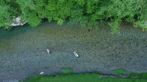 Drone rises over forest mountain river and man figure Stock Footage 102346561