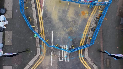 Drone rises over road barriers revealing pothole and low bridge warning Stock Footage 328066632