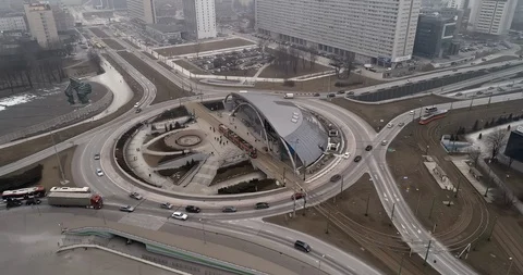 Drone rises over the roundabout of Zi?tek, around which cars, trams and buses Stock-Footage 106913046