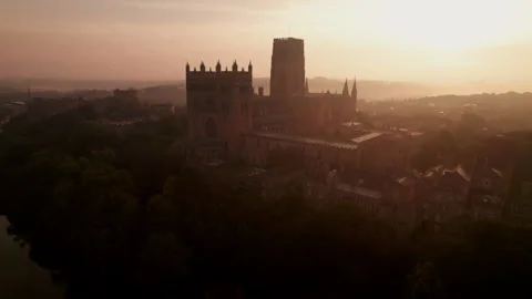 Drone rises slowly in front of Durham Cathedral to reveal Durham Stock Footage 278027348