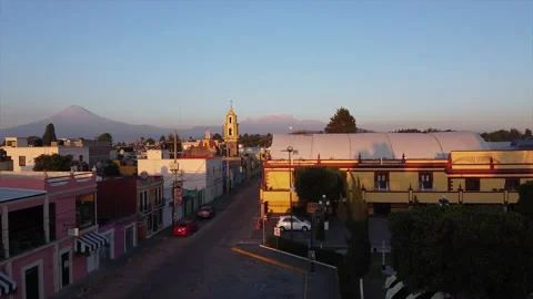 A drone rises slowly over the streets of Mexico's historic city of Cholula Stock Footage 170182925