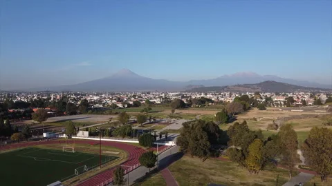 A drone rises slowly over the streets of Mexico's historic city of Cholula Video stock 170182997
