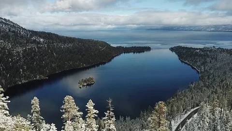 Drone rises up snowy trees and reveals Emerald Bay 스톡 동영상 83229672