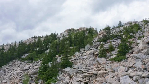 The drone rises to the top of the mountain along the slope. Stock Footage 114058467